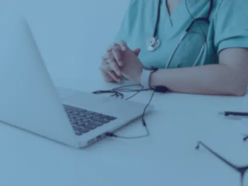 Medical professional looking at computer